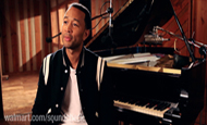 John Legend sitting at piano